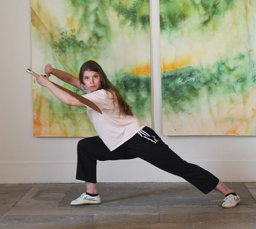 Neeve Moule Drige in front of her paintings